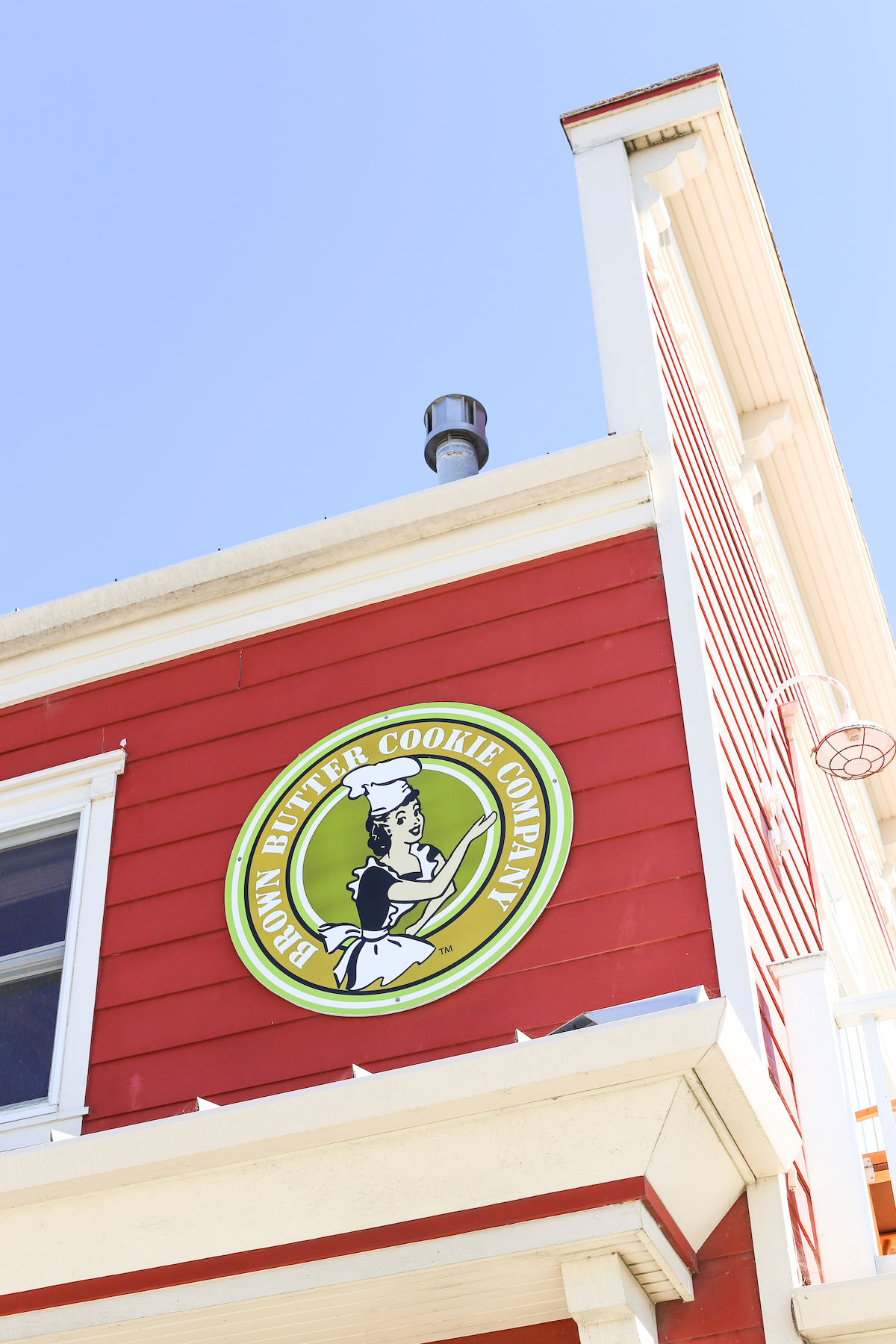 Red exterior and green logo of the Brown Butter Cookie Company in Cayucos